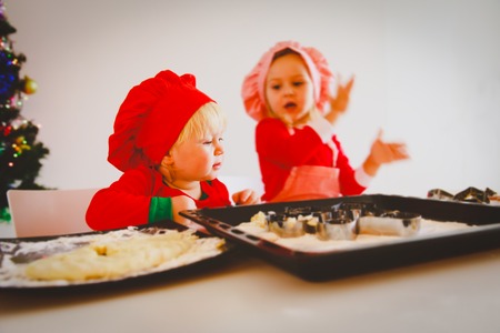 little girls making christmas cookies at homeの写真素材