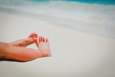 child feet in sand at summer beachの写真素材