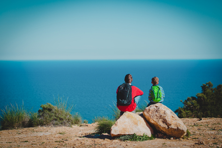 father and son hiking travel in nature, family touristsの写真素材