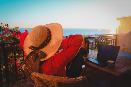 remote work concept- young woman with laptop on scenic terraceの写真素材