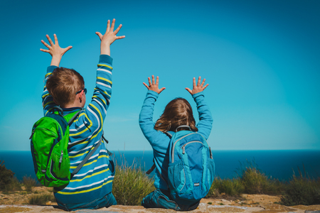 happy boy and girl enjoy travel in nature, looking at viewの写真素材
