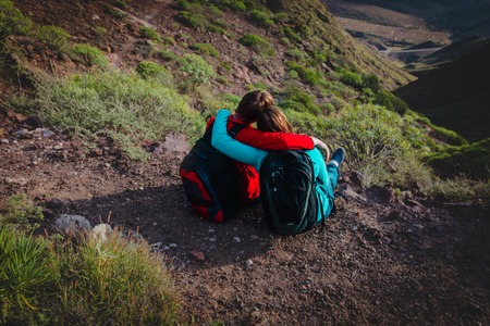 happy loving couple hiking travel in mountainsの写真素材