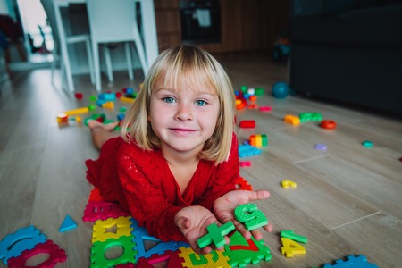 happy little girl play with numbers at homeの写真素材