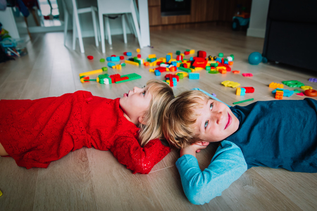 happy little girl and boy enjoy play homeの写真素材