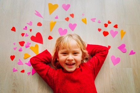 happy cute little girl play with hearts from paper, valentine dayの写真素材