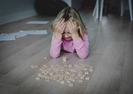 little girl tired of learning letters, kid hate doing homework