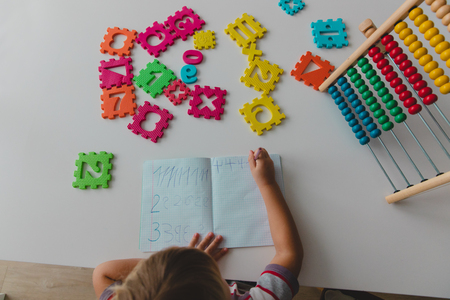 little girl learn to write and culculate numbersの写真素材