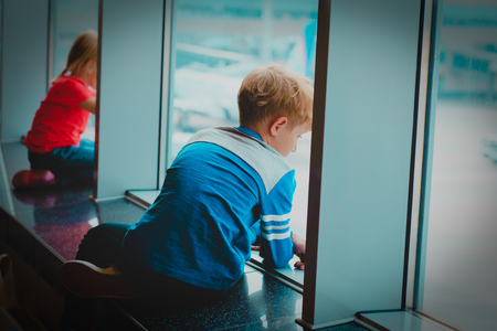 little boy and girl waiting plane in airportの写真素材