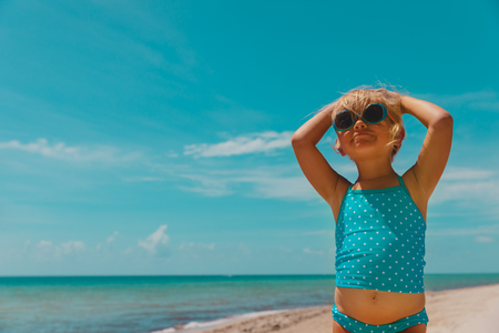 cute little girl enjoy tropical beach vacationの写真素材