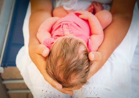 mother holding newborn baby girl, parenting and care