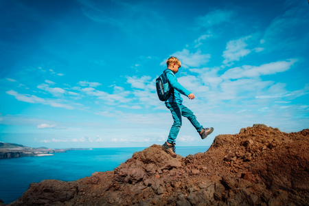 boy hiking in scenic mountains near seaの写真素材