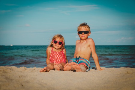 happy kids- boy and girl relax at beach