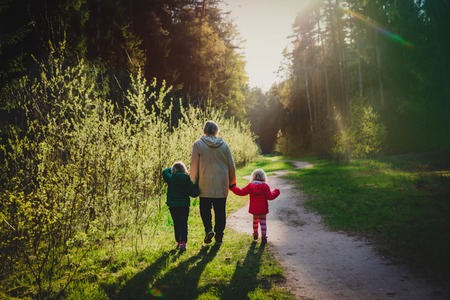 grandmother with kids walk in nature at sunsetの写真素材