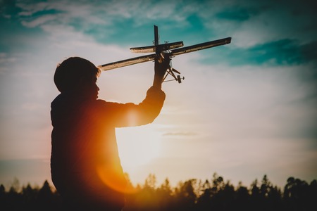 boy play with toy play in sunset natureの写真素材