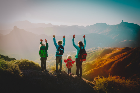 happy family travel in mountains at sunsetの写真素材