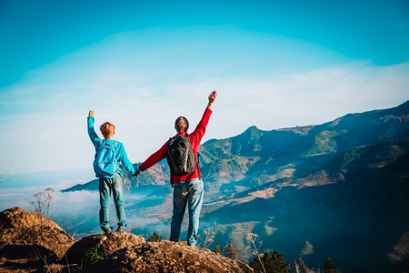 father and son travel in nature, family hiking in mountainsの写真素材