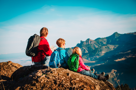 happy father and kids travel hiking in mountainsの写真素材