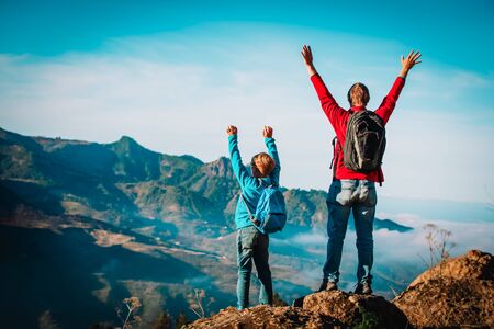 father and son travel in nature, family hiking in mountainsの写真素材