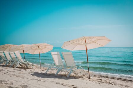 Beach chairs on tropical vacation, travel to sea concept