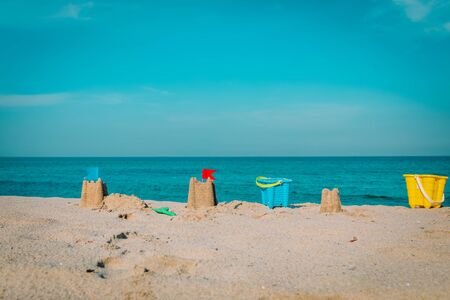 Sand castle on beach vacation and toys