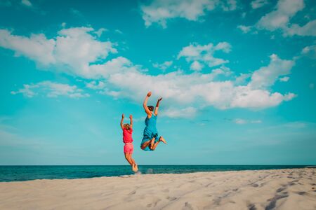 happy family- mom and daughter- jumping on beach
