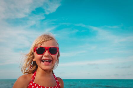 happy cute smiling girl at summer beachの写真素材