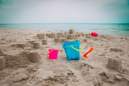 Kids toys and sand castle on the beachの写真素材