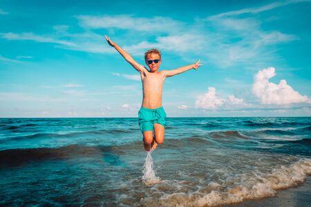 happy little boy play on beach, kid enjoy vacationの写真素材