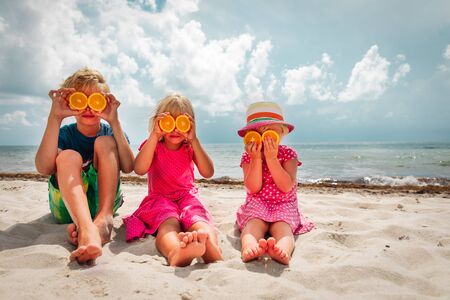 happy boy and girls enjoy summer vacation, showing orange eyesの写真素材