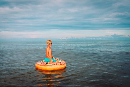 happy boy swimming at tropical beach, child relax at seaの写真素材
