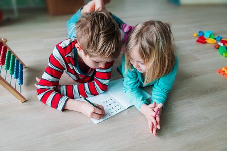 boy and girl learn to count and write numbers