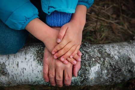 grandmother and grandchild hand in nature, parenting conceptの写真素材
