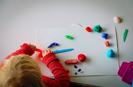 Child playing with clay molding shapes, learning through playの写真素材