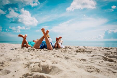 father with son and daughter relax on beachの写真素材