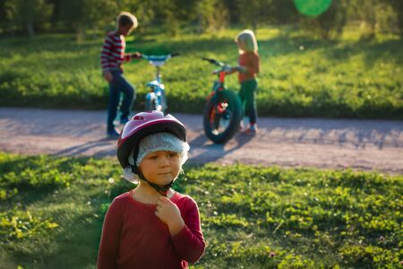 family on bike ride, kids with bikes in sunset natureの写真素材