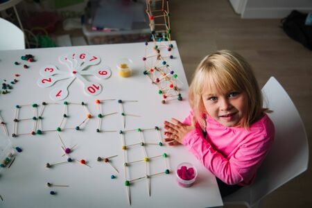 girl making letters, geometric shapes from sticks and clay, engineering and STEMの写真素材
