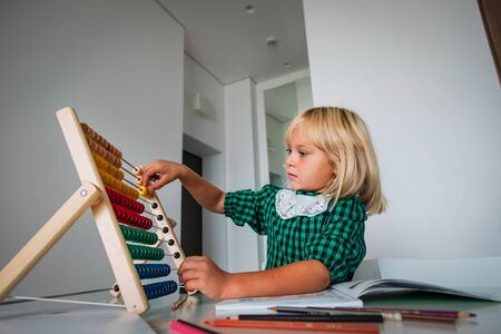 little girl do homework, child count on abacus, learningの写真素材