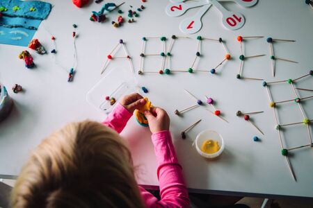 girl making letters, geometric shapes from sticks and clay, engineering and STEMの写真素材
