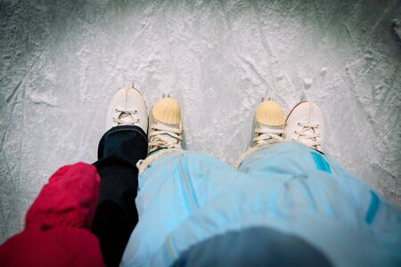 mother and child skating together in winter nature