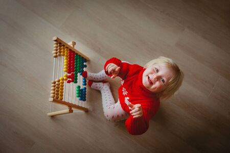 little girl playing with abacus, learning numbersの写真素材