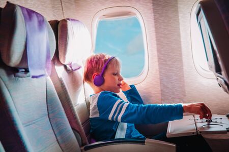 little boy with headset play with toy plane in flightの写真素材