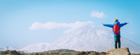 happy little boy hiking in mountains, child looking at Teide, Tenerife, Spainの写真素材