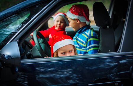 christmas car travel- happy kids travel by car in winter