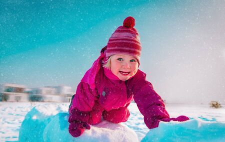 cute little girl enjoy play in winter snow