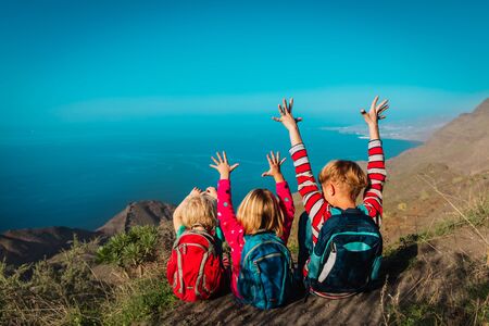 happy kids-boy and girls- travel in mountains near sea, family in Canary islands, Spainの写真素材