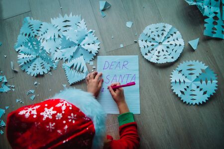 little girl writing letter to Santa, family Christmas activitiesの写真素材