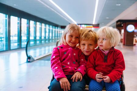 happy kids-boy and girls- travel in the airport, family vacationの写真素材