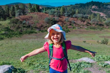 happy cute little girl enjoy hiking in nature, family travelの写真素材