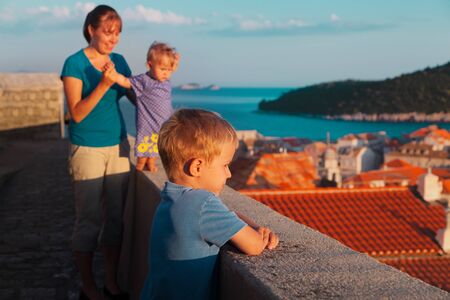 happy family looking at Dubrovnik, Croatia from city walls, mom and kids travelの写真素材