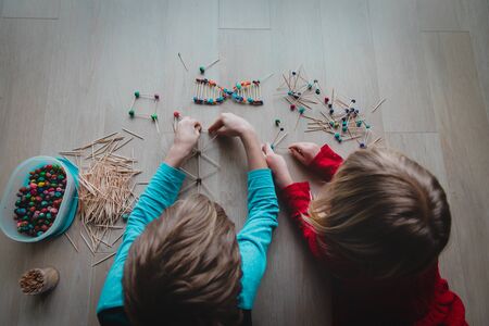 boy and girl making models from sticks and clay, engineering and STEMの写真素材